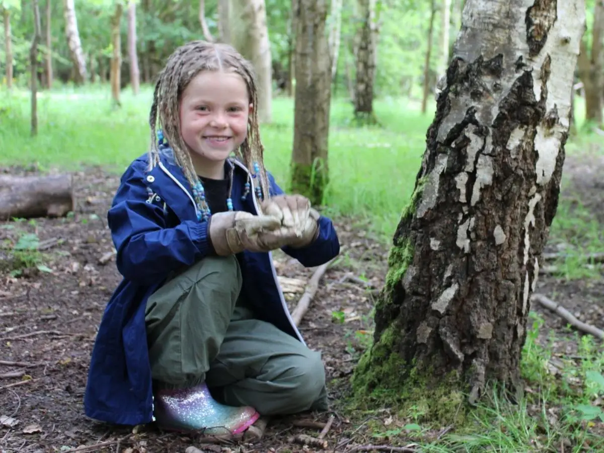child in the forest on a bushcraft activity