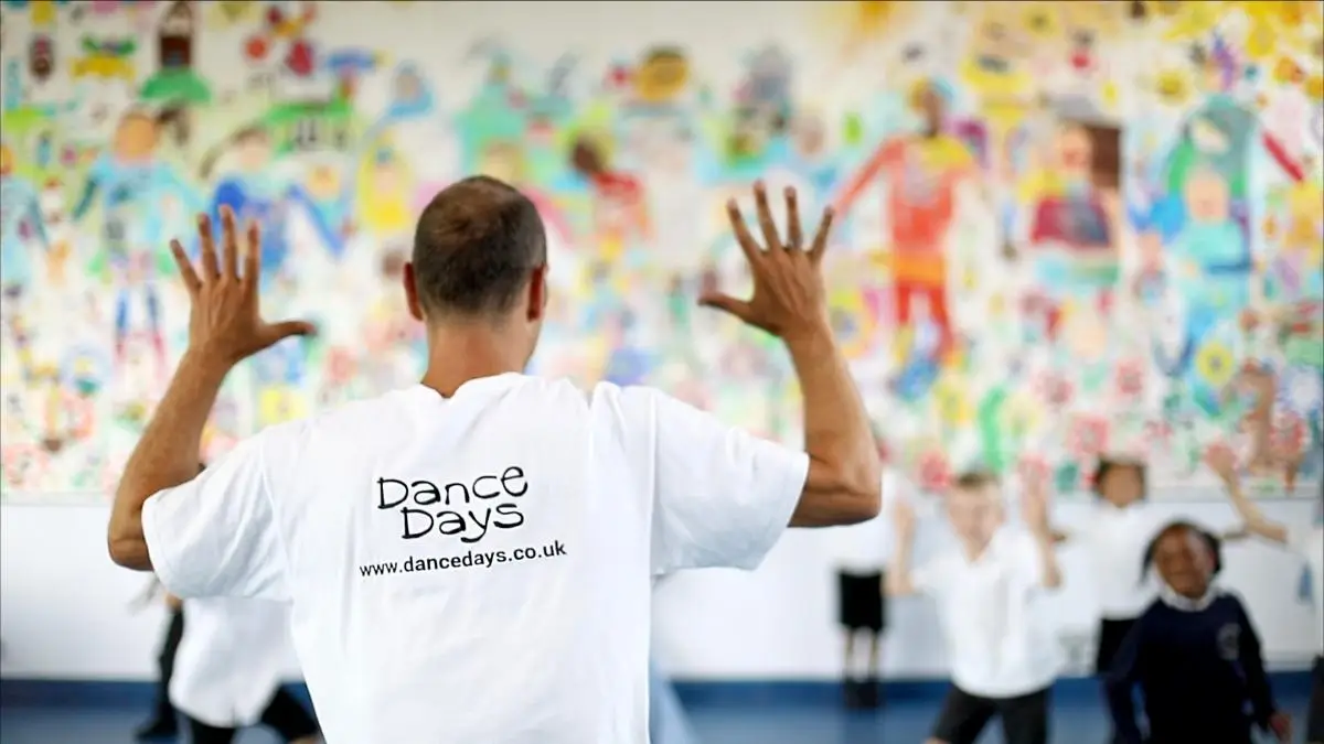 dance workshop teacher with a class of school children