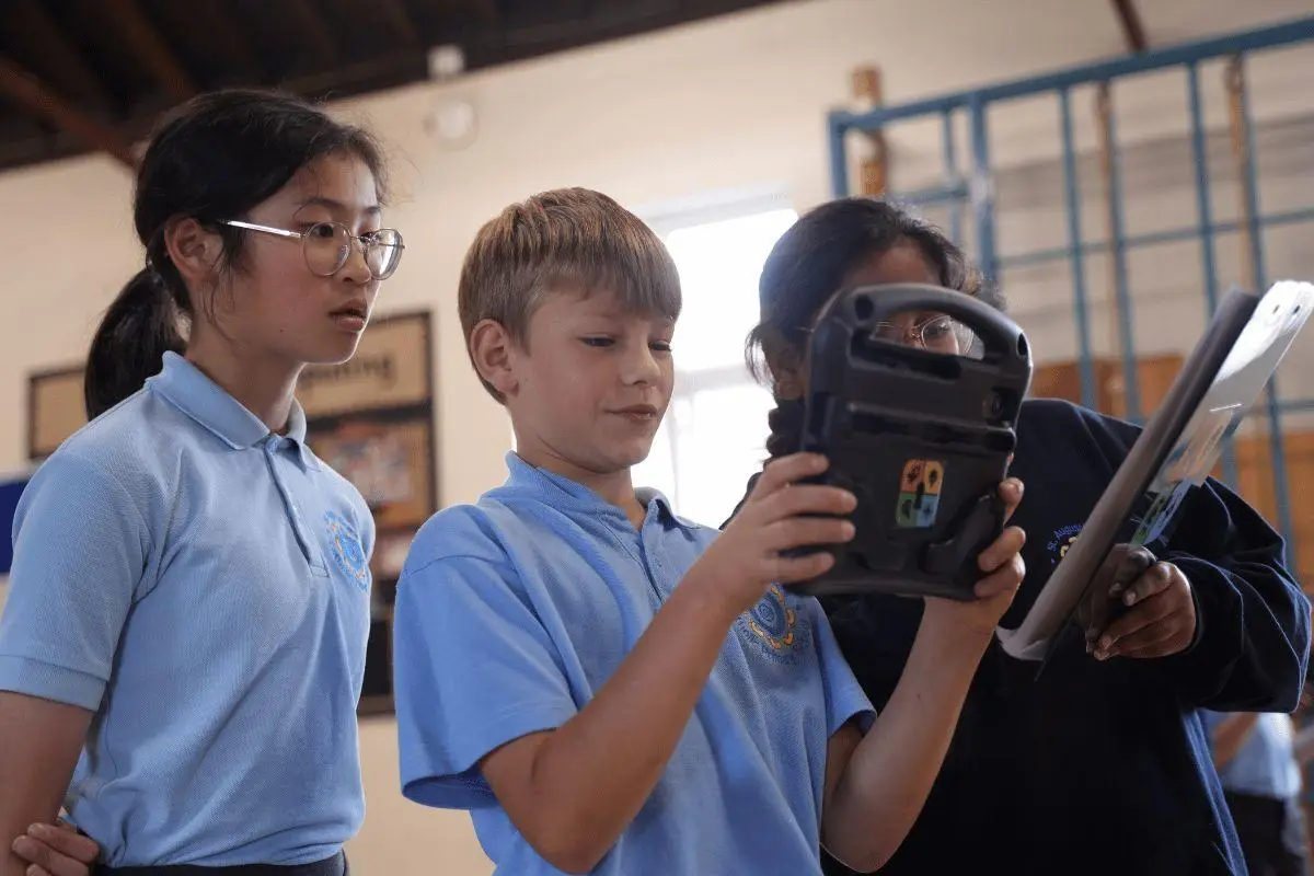 children in school hall playing an augmented reality ancient greeks history game