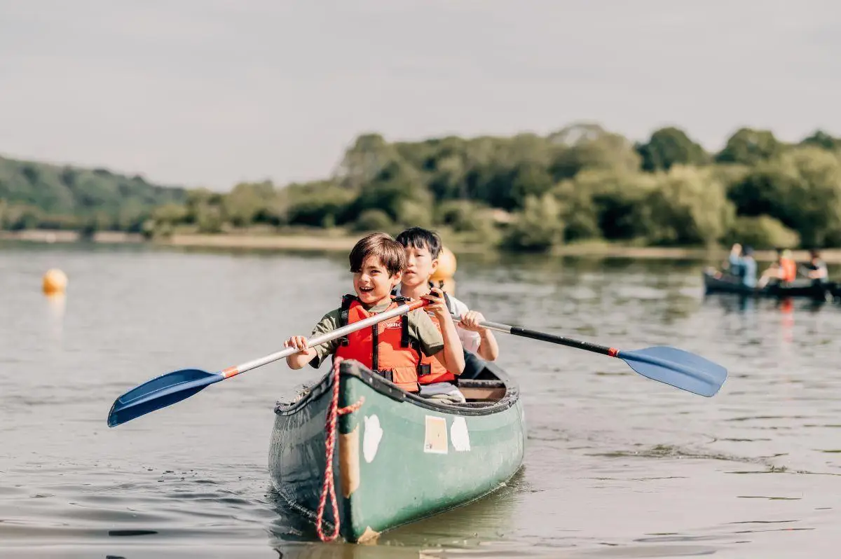 school children in a canadian canoe on a lake