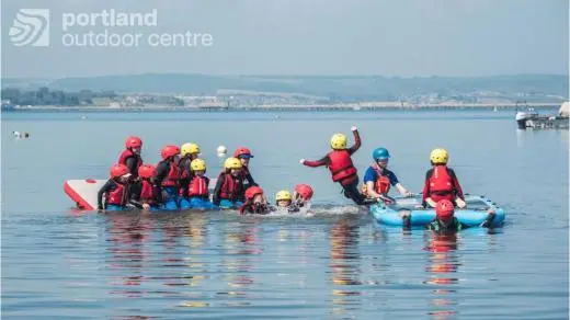 group of school children in the sea at portland outdoor centre