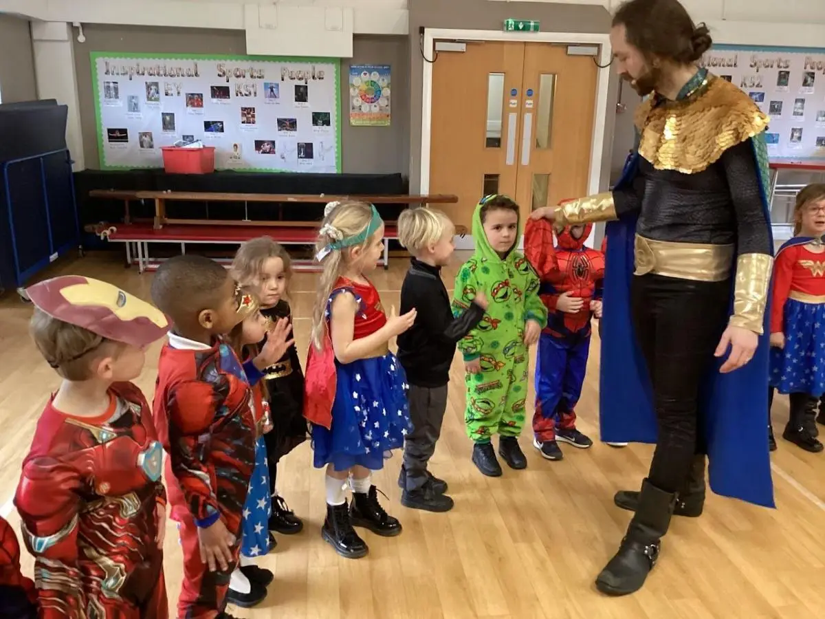 school children dressed as super heroes