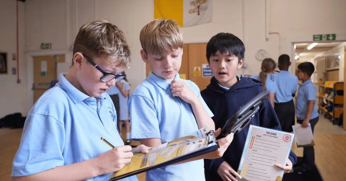 children in school hall enjoying an augmented reality WWII history game